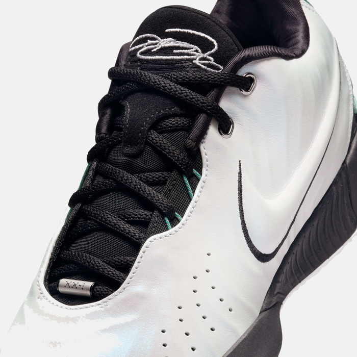 Nike Lebron XXI "Conchiolin" basketball shoes close-up showing black mesh tongue, white synthetic upper, perforations, and signature logo.