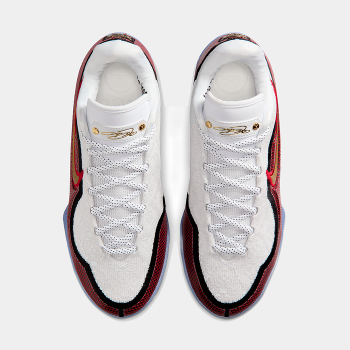 Nike LeBron XXIII "Grand Opening" basketball shoes, top view showing white textured upper with red and black accents, gold details on tongue.