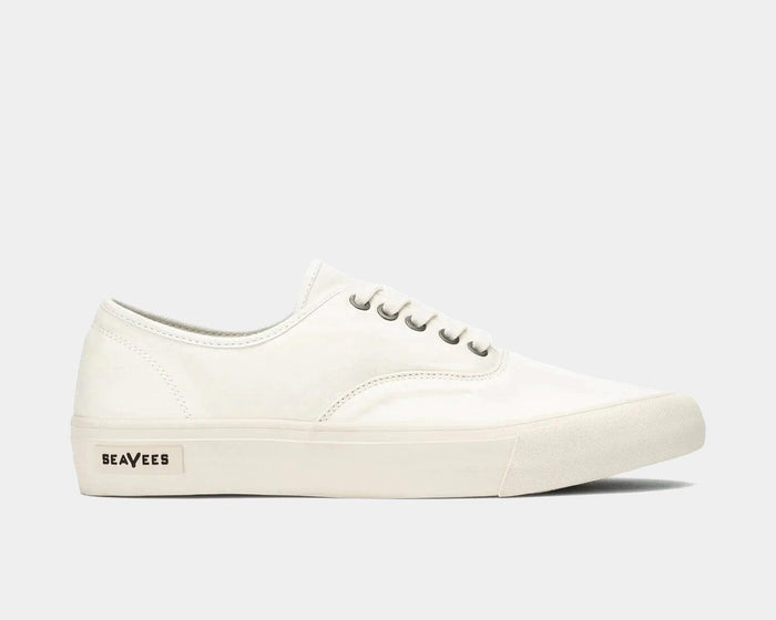 SeaVees Legend Sneaker Standard casual sneakers in white canvas with metal eyelets and rubber sole, side view.