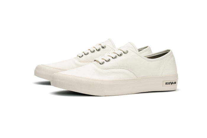 SeaVees Legend Sneaker Standard sneakers in white canvas with metal eyelets, lace-up design, and branded sole, side angled view.