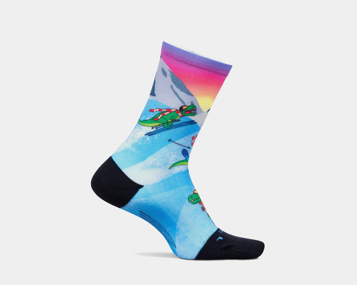 Feetures Limited Edition "Ski-Rex" Elite Light Cushion Mini Crew socks with colorful skiing dinosaur and winter mountain design, side view.