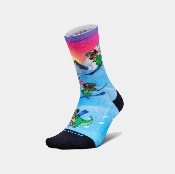 Feetures Limited Edition "Ski-Rex" Elite Light Cushion Mini Crew socks with dinosaur skiing design, gradient blue and pink cuff, and black toe and heel, side view.
