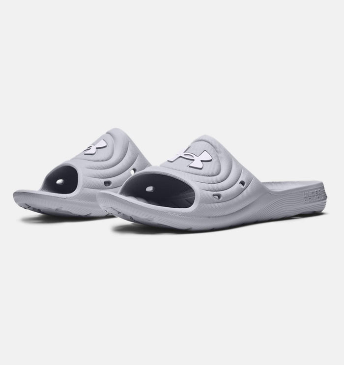 Under Armour Locker IV SL slides in light gray with textured synthetic upper, open-toe design, and durable outsole, angled front view.
