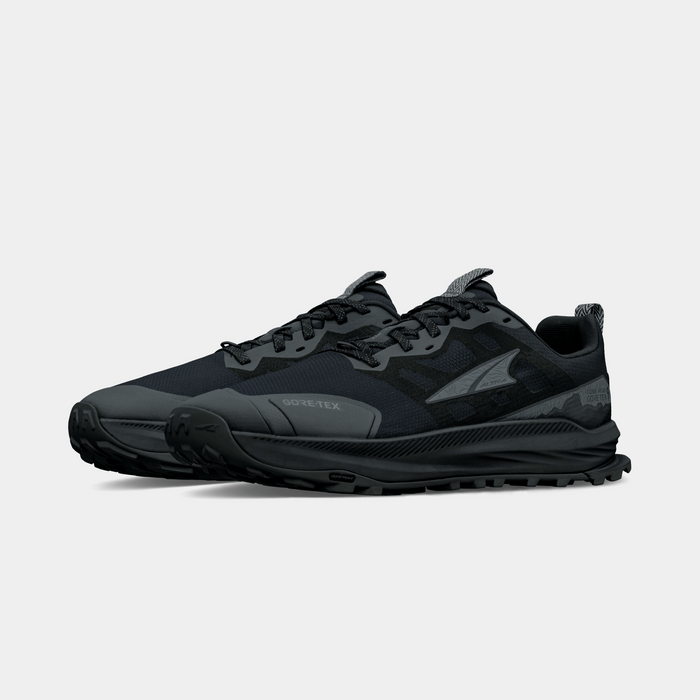 Altra Lone Peak 9 GTX trail running shoes in black with Gore-Tex waterproof upper and rugged outsole, front-side angle.
