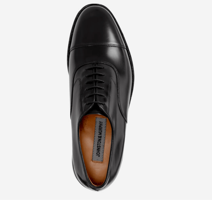 Johnston & Murphy Melton Cap Toe dress shoe in black leather with lace-up closure and cap toe design, top view.