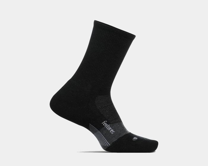 Feetures Merino 10 Ultra Light Cushion Mini Crew socks in black with targeted compression and seamless toe, side view.