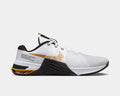 Nike Metcon 8 training shoes side view in white with gold accents, breathable mesh upper, and black textured midsole.