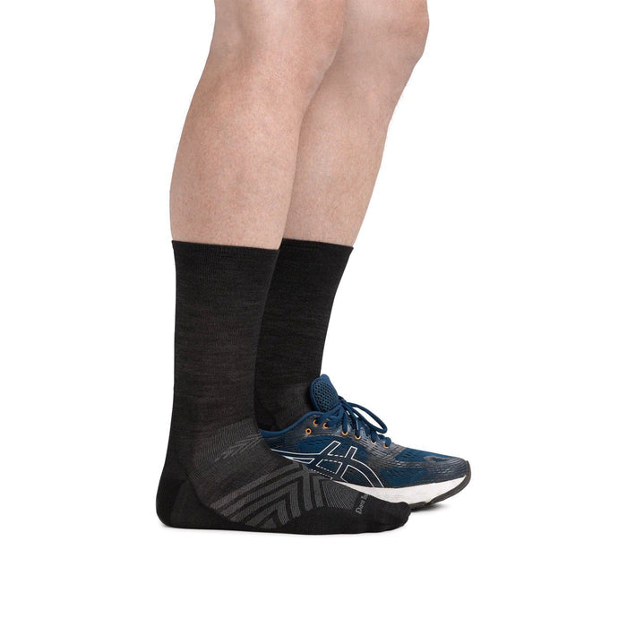 Darn Tough Micro Crew Ultra-Lightweight Running Sock in black with gray accents and seamless construction, side view worn.