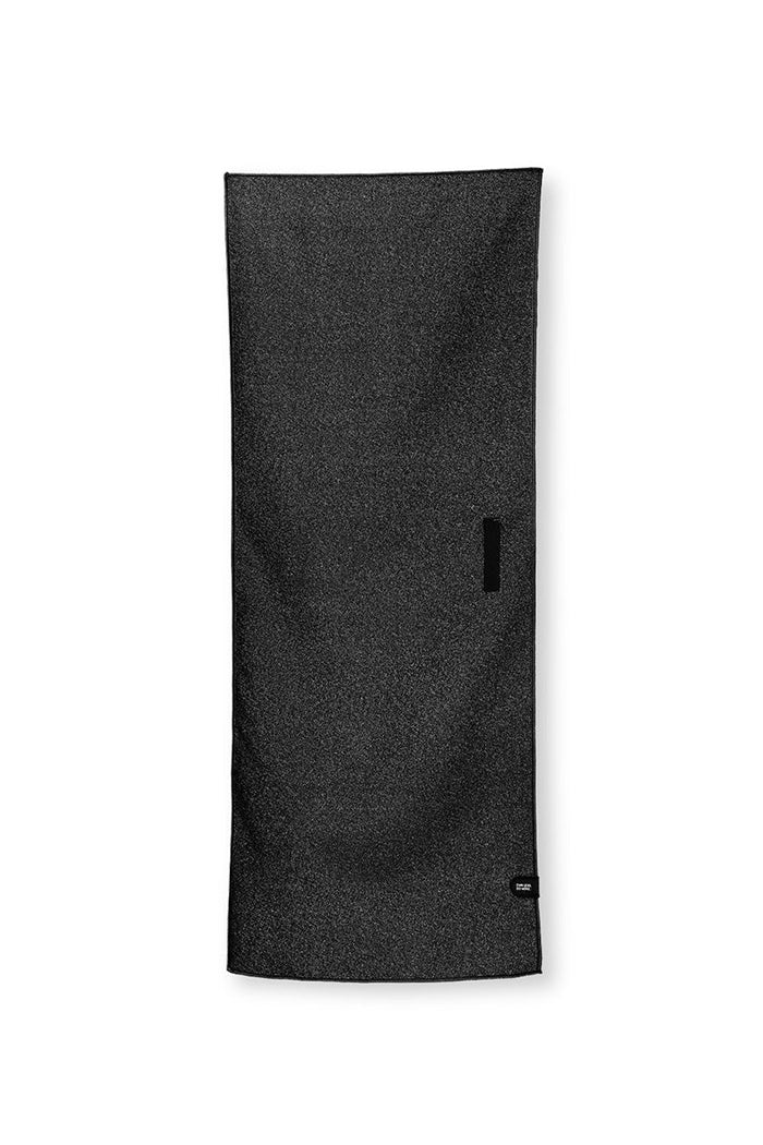 Nomadix Mini Towel in black with smooth texture and compact design, front view showing brand tag detail.