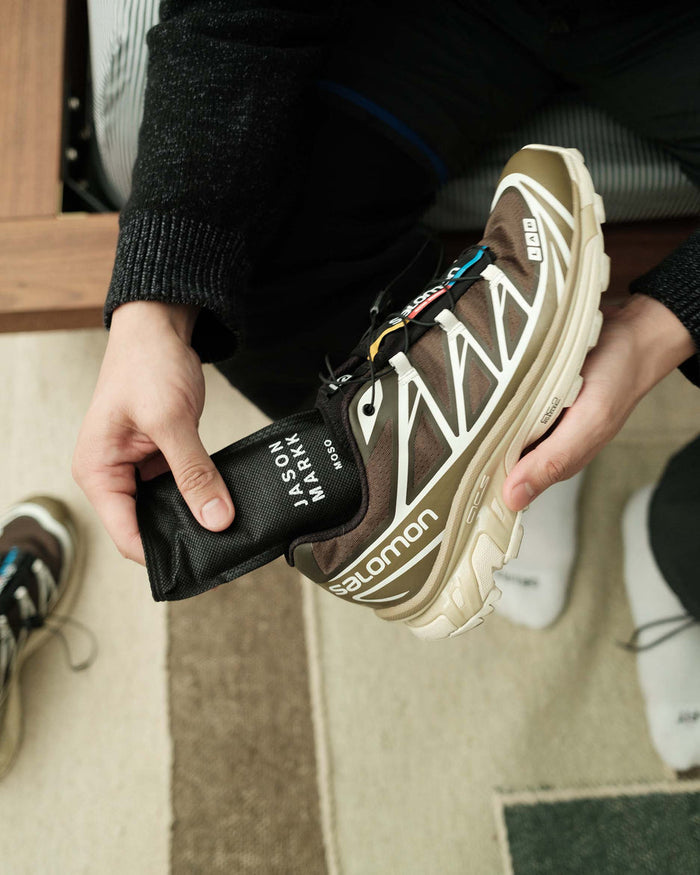 Jason Markk Moso Freshener Shoe Inserts in black with printed branding, shown being placed into a shoe for odor elimination.