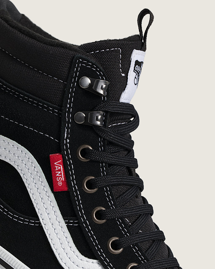 Vans MTE Sk8-Hi Waterproof Insulated Shoe in black with white stitching, metal eyelets, and iconic side stripe, close-up view.