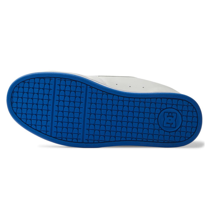 DC Footwear Net skate shoes outsole in bright blue rubber featuring textured tread pattern and DC logo.