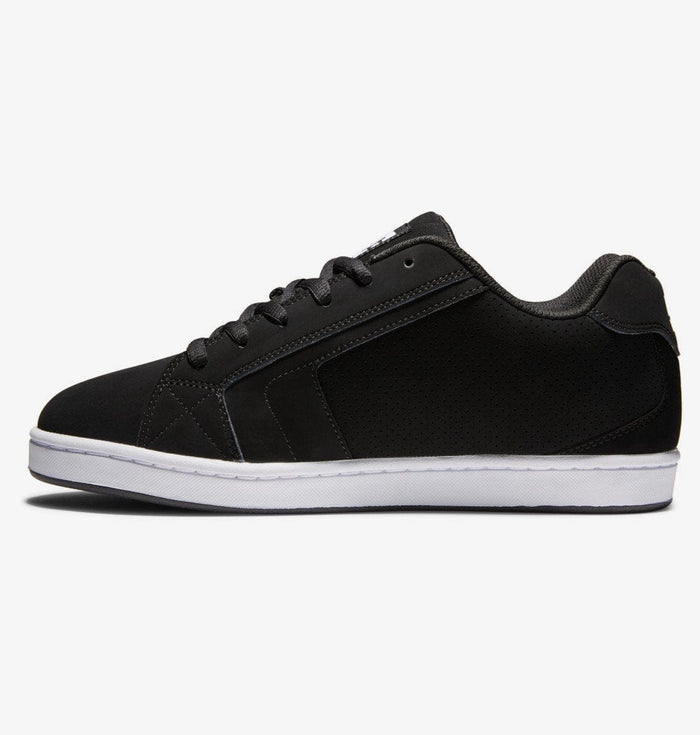 DC Footwear Net sneakers in black with perforated details, padded collar, and white rubber sole, side view.