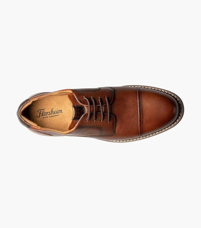 Florsheim Norwalk Cap Toe Oxford dress shoe in brown leather with fine grain texture and tonal stitching, top view showing lace-up design and cushioned interior.