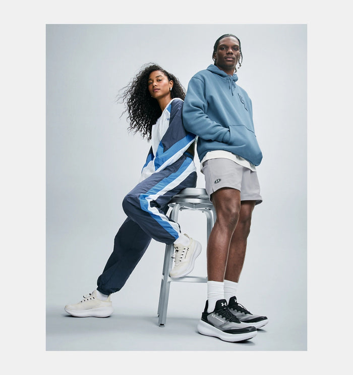Under Armour Nova SlipSpeed™ sneakers in white and black with lightweight design and SlipSpeed™ heel, worn in a casual lifestyle setting.