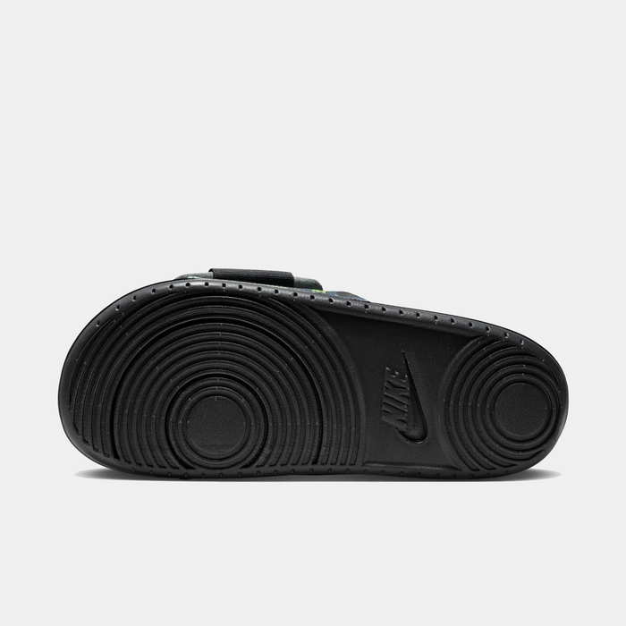 Nike Offcourt Adjustable Slide PR sandals with textured black outsole featuring circular traction patterns and Nike logo, sole/bottom view.