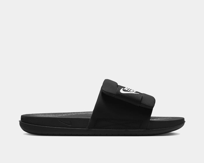 Nike Offcourt Adjustable Slide sandals in black with a soft foam sole and adjustable strap featuring the white Nike logo, side view.