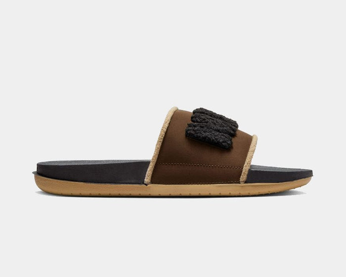 Nike Offcourt Slide SE sandals in brown and black with fleece-textured strap detail and cushioned sole, side view.
