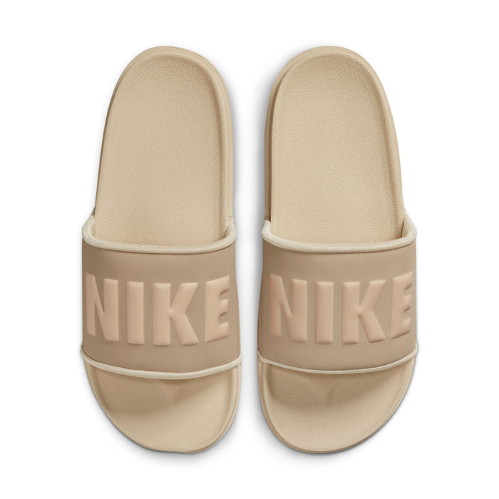 Nike Offcourt Slide sandals in beige with textured footbed and bold Nike logo on wide strap, top view.
