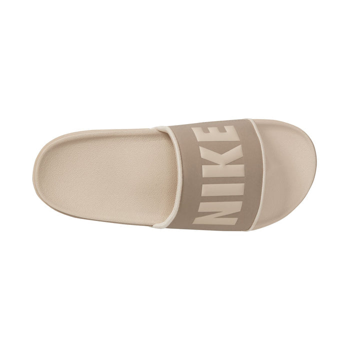Nike Offcourt Slide sandals in beige featuring oversized Nike branding on the strap, top view showing textured footbed and cushioned design.