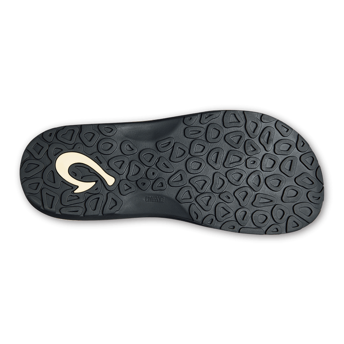 OluKai Ohana Pa'i sandal outsole in black with textured pod design and embossed logo offering grip and durability.
