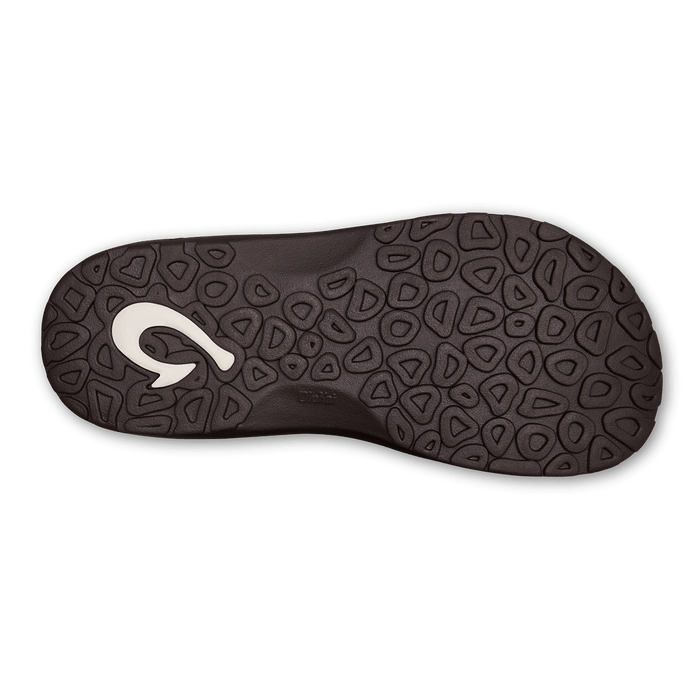 OluKai Ohana sandal outsole featuring textured dark brown rubber with a coral pattern and embossed logo.