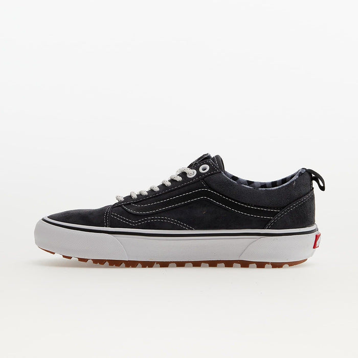 Vans Old Skool MTE sneakers in black suede with white stitching, rugged gum outsole, and pull tab, side view.