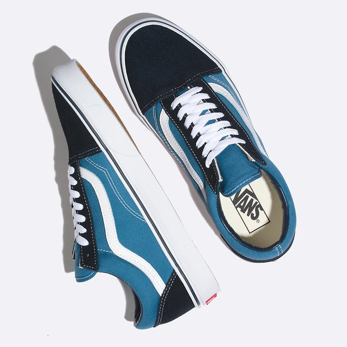 Vans Old Skool sneakers in blue and black with white side stripe, canvas and suede upper, and white laces, top angle view.