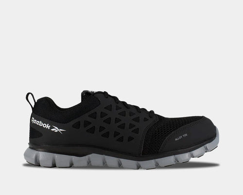 Reebok Work Sublite Cushion Work shoes in black with alloy toe protection, mesh upper, and lightweight gray outsole, side view.
