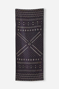 Nomadix Original Towel in black with geometric tan patterns, lightweight and versatile, front view.