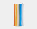 Nomadix Original Towel featuring vibrant striped design in orange, yellow, teal, blue, and beige, front view.