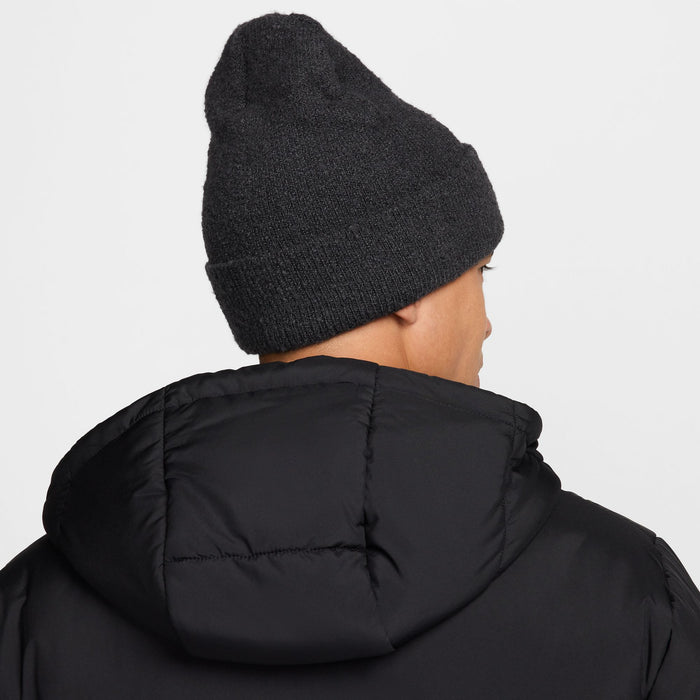 Nike Peak beanie in dark gray knit fabric with a folded cuff, back view showing textured material.