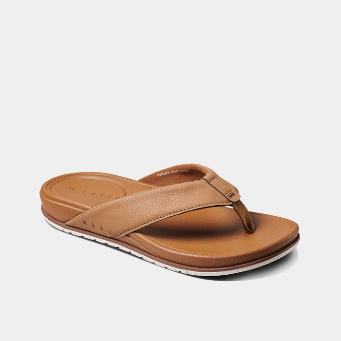 Reef Phantom Bronzer sandals in tan with textured synthetic leather straps and cushioned footbed, angled side view.