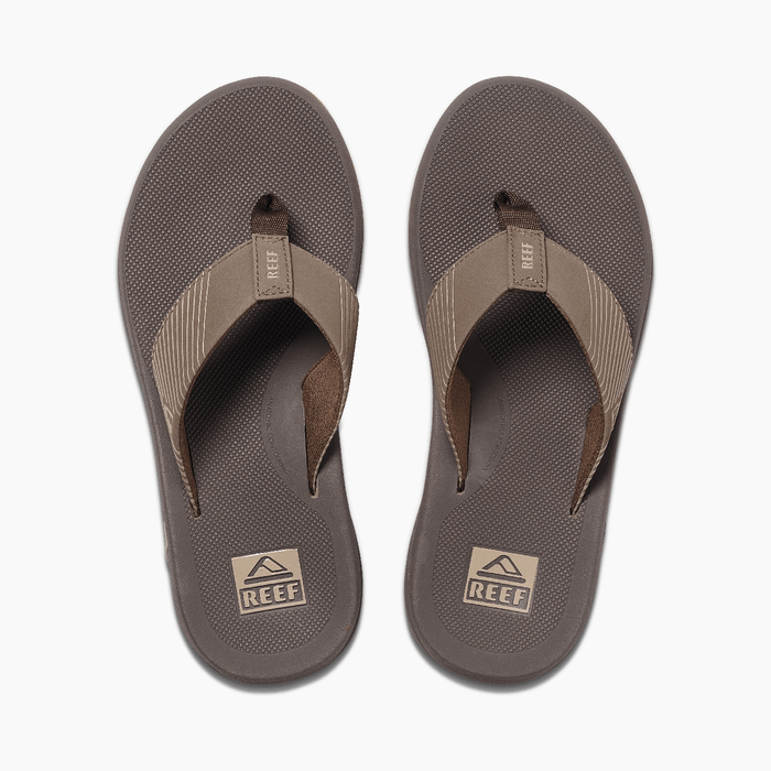 Reef Phantom II flip-flops in brown with textured footbeds and striped fabric straps, top view.