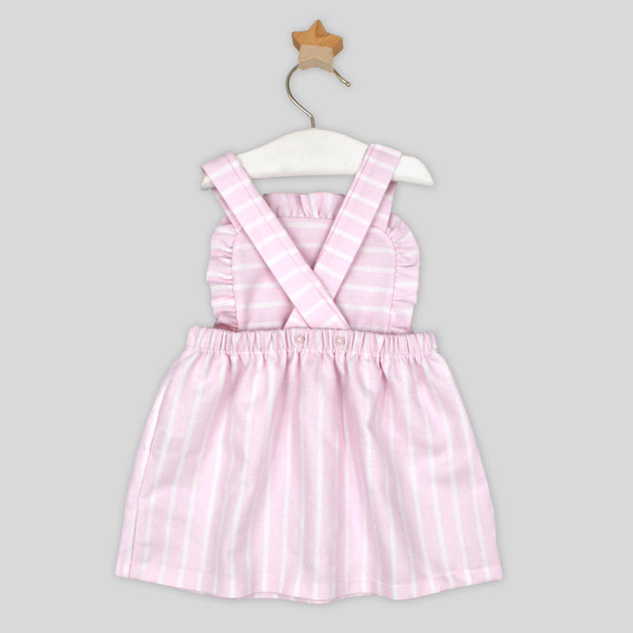Pink striped dress on a hanger against a gray background