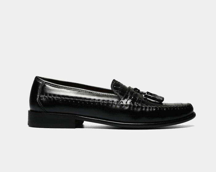 Florsheim Pisa dress loafers in black leather with tassel detailing and stitched accents, side view.