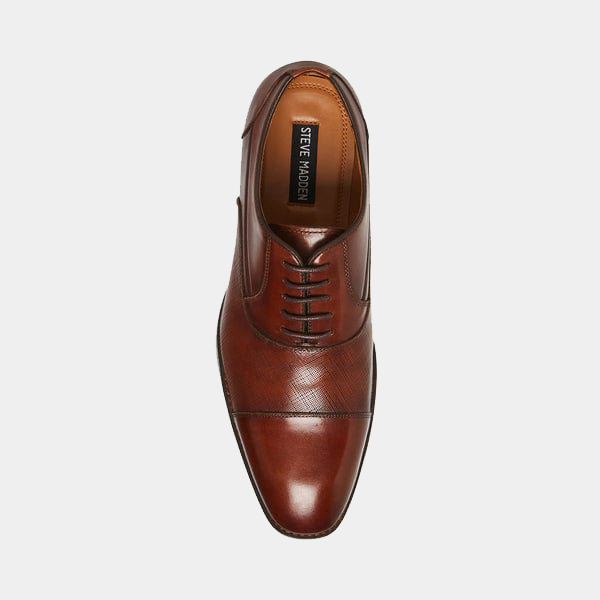 Steve Madden Proctor dress shoes in rich brown leather with textured cap toe detail and sleek lace-up design, top view.