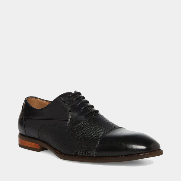 Steve Madden Proctor dress shoes in black leather with textured panel details and polished cap toe, side angle view.