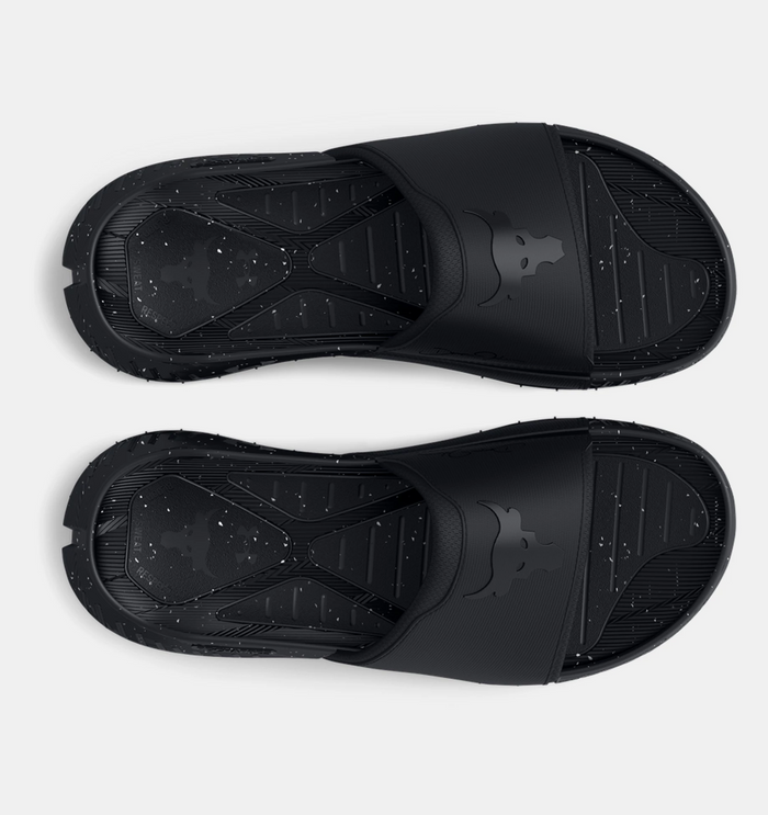 Under Armour Project Rock 3 Slides in black with speckled textured footbed and bold Brahma Bull logo on strap, top view.
