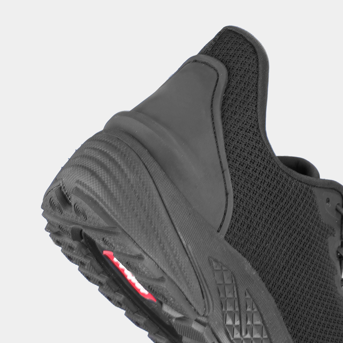 Propét One Velocity Step-In Sneaker back view showing black mesh upper, sturdy heel counter, and textured rubber outsole.