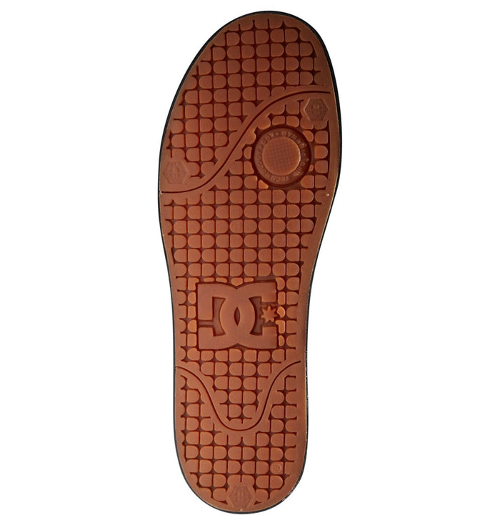 DC Footwear Pure Mid shoe outsole in brown rubber with textured tread design and embossed logo detailing.