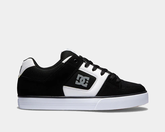 DC Footwear Pure skate shoes in black and white with padded collar, durable leather upper, and DC logo on the side, side view.
