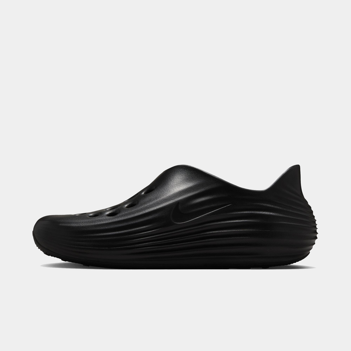 Nike ReactX Rejuven8 slip-on shoes in sleek black with textured wave-like design and ventilation holes, side view.