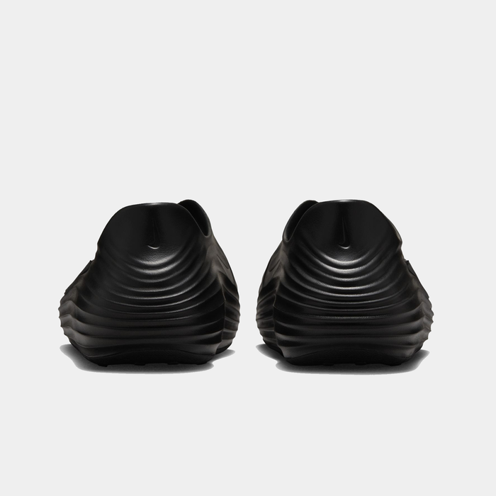 Nike ReactX Rejuven8 slip-on shoes in black with ribbed textured design and rounded heel, back view