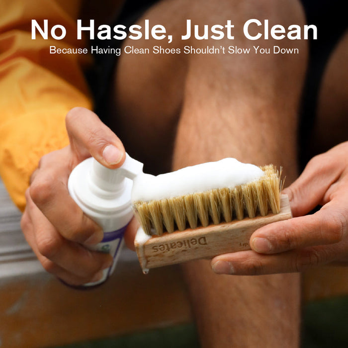 Jason Markk Ready-To-Use Clean Kit featuring foaming spray bottle and wooden brush with natural bristles, lifestyle context showing usage.