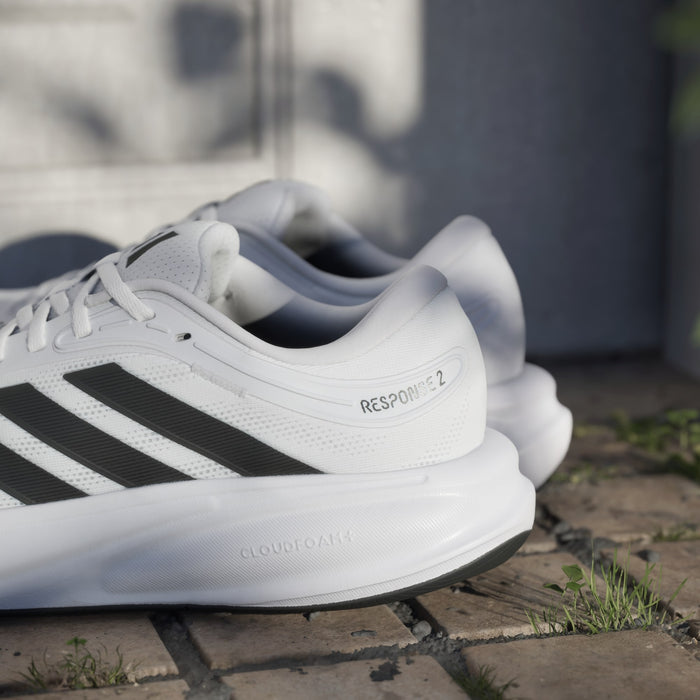 Adidas Response 2 running shoes in white with black stripes, Cloudfoam cushioning, and "Response 2" branding, side angle.