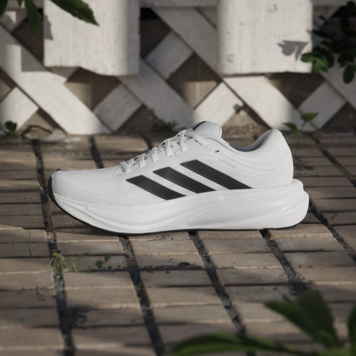 Adidas Response 2 running shoes in white with black stripes, mesh upper and cushioned midsole, side view.