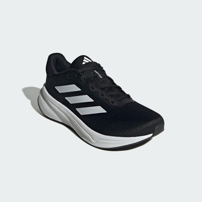 Adidas Response running shoes in black mesh with white sole and three-stripe design, angled front view