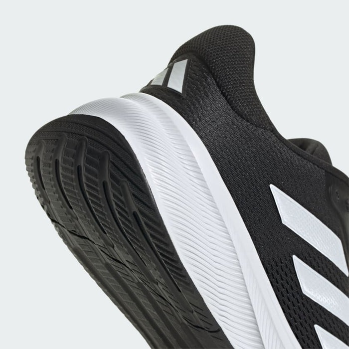 Adidas Response running shoe with lightweight black mesh upper, white midsole, and traction-enhanced black outsole, angled heel-side view.