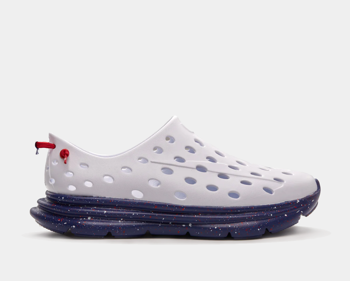 Kane Revive recovery shoes in white with perforated upper and navy blue sole featuring red speckle design, side view.